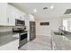 Modern kitchen features stainless steel appliances, granite countertops, and ample cabinet space at 2511 Stagnaro Rd, North Port, FL 34287