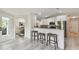 Eat-in kitchen with bar stool seating and views into the dining room at 2511 Stagnaro Rd, North Port, FL 34287