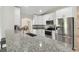 Bright modern kitchen with stainless steel appliances, granite countertops, and white cabinetry at 2511 Stagnaro Rd, North Port, FL 34287