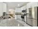 Beautiful kitchen showcasing granite countertops, stainless steel appliances, and abundant cabinet space at 2511 Stagnaro Rd, North Port, FL 34287