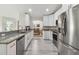 Bright, spacious kitchen with modern appliances and granite countertops, open to the dining area at 2511 Stagnaro Rd, North Port, FL 34287