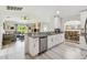 Open kitchen with granite countertops and stainless steel appliances looks out to living and dining areas at 2511 Stagnaro Rd, North Port, FL 34287