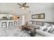 Open-concept living area featuring a comfortable sofa, modern kitchen, and stylish decor at 2511 Stagnaro Rd, North Port, FL 34287