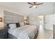 Spacious main bedroom featuring a stylish bed, ceiling fan, and pristine light-colored floors at 2511 Stagnaro Rd, North Port, FL 34287