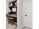 Functional home office featuring a built-in desk, stool and shelves at 2511 Stagnaro Rd, North Port, FL 34287