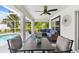 Screened-in patio featuring outdoor seating, a ceiling fan, and a view of the pool at 2511 Stagnaro Rd, North Port, FL 34287