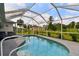 Sparkling screened-in pool with lounge chairs and a well-maintained deck at 2511 Stagnaro Rd, North Port, FL 34287