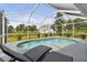 Relaxing screened-in pool area with lounge chairs and lush landscaping at 2511 Stagnaro Rd, North Port, FL 34287