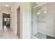 Modern tiled shower with glass door located off a bedroom hallway at 2511 Stagnaro Rd, North Port, FL 34287