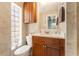 Bathroom with a vanity, toilet and a large mirror at 2832 Greenbriar St, Sarasota, FL 34237