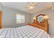 Cozy bedroom featuring a wooden bed frame and dresser with lamps at 4159 Heron Way # E303, Bradenton, FL 34205