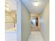 Bright entryway with tile flooring leading to the living room and kitchen at 4159 Heron Way # E303, Bradenton, FL 34205