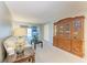 Living room featuring a comfy sofa and a large wooden cabinet at 4159 Heron Way # E303, Bradenton, FL 34205