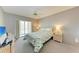 Bedroom with patio access and ceiling fan at 4159 Heron Way # E303, Bradenton, FL 34205