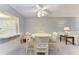 Charming dining area with a round table and four chairs, adjacent to kitchen at 4159 Heron Way # E303, Bradenton, FL 34205