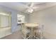 Bright dining area features a round table and chairs, offering a view of the kitchen at 4159 Heron Way # E303, Bradenton, FL 34205