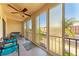 Relaxing screened balcony with wicker furniture and partial water view at 4159 Heron Way # E303, Bradenton, FL 34205