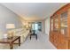 Spacious living room with light beige couch and wood cabinet at 4159 Heron Way # E303, Bradenton, FL 34205