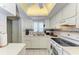 Bright kitchen features white cabinets, granite countertops, and modern appliances at 4159 Heron Way # E303, Bradenton, FL 34205