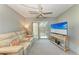 Living area with a large TV, comfy seating, and access to a balcony at 4159 Heron Way # E303, Bradenton, FL 34205