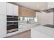 Modern kitchen with stainless steel appliances and white and wood cabinets at 1734 Wisconsin Ln, Sarasota, FL 34239