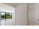 Light and airy hallway with doors to bedrooms and a view into a bedroom with balcony at 1734 Wisconsin Ln, Sarasota, FL 34239