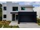 Modern two-story home with black garage door and light-colored exterior at 1734 Wisconsin Ln, Sarasota, FL 34239