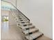 Modern glass and metal staircase with light wood steps at 1734 Wisconsin Ln, Sarasota, FL 34239