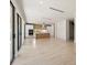 Open living area with light wood flooring and large windows at 1734 Wisconsin Ln, Sarasota, FL 34239