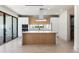 Modern kitchen with island, stainless steel appliances, and light wood cabinets at 1734 Wisconsin Ln, Sarasota, FL 34239