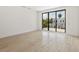 Spacious bedroom featuring light wood floors and access to a private balcony at 1734 Wisconsin Ln, Sarasota, FL 34239