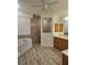Bathroom with soaking tub, tiled shower, luxury vinyl plank flooring, and double sink vanity at 15 Tee View Pl, Rotonda West, FL 33947