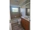 Bathroom features a shower and tub combination, wooden vanity, and neutral ceramic tile at 15 Tee View Pl, Rotonda West, FL 33947