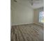 Bright bedroom features a ceiling fan, wood floors, and a window bringing in natural light at 15 Tee View Pl, Rotonda West, FL 33947