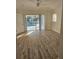 Bedroom features luxury vinyl plank flooring, sliding glass doors, and a view of the pool at 15 Tee View Pl, Rotonda West, FL 33947
