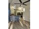 Open kitchen with stainless steel appliances, breakfast bar, and decorative wood-look accent wall at 15 Tee View Pl, Rotonda West, FL 33947