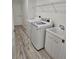 Bright laundry room with stainless steel washer and dryer and a utility sink at 15 Tee View Pl, Rotonda West, FL 33947