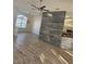 Open-concept living area with stylish flooring, wood-look accent wall, and views towards the kitchen area at 15 Tee View Pl, Rotonda West, FL 33947