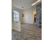Open floor plan showcasing wood-look floors and decorative accent wall creating a modern and stylish space at 15 Tee View Pl, Rotonda West, FL 33947