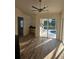 Bright living space with views of the pool, featuring wood-look floors and a desk area with natural light at 15 Tee View Pl, Rotonda West, FL 33947