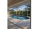 Backyard pool is surrounded by a screen enclosure for a refreshing and pest-free retreat at 15 Tee View Pl, Rotonda West, FL 33947
