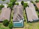 Aerial view of home with screened in pool and patio area surrounded by tropical trees at 7249 Orchid Island Pl, Bradenton, FL 34202
