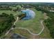 Scenic aerial view of a lush golf course with winding paths and tranquil lake, creating a picturesque setting at 7249 Orchid Island Pl, Bradenton, FL 34202