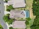 Overhead view of a home with a screened in pool and lush green backyard at 7249 Orchid Island Pl, Bradenton, FL 34202
