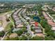 Aerial view of a neighborhood with mature trees, bodies of water, and golf course nearby at 7249 Orchid Island Pl, Bradenton, FL 34202