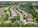Aerial view of a neighborhood with a golf course and ponds nearby at 7249 Orchid Island Pl, Bradenton, FL 34202