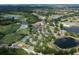 Picturesque aerial view of the community featuring lush landscapes, a golf course, and beautiful lakes at 7249 Orchid Island Pl, Bradenton, FL 34202