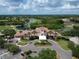 Stunning aerial view of a sprawling clubhouse overlooking pristine golf courses and serene lakes, a true paradise for recreation at 7249 Orchid Island Pl, Bradenton, FL 34202