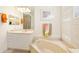 Bathroom featuring vanity, soaking tub and modern fixtures at 7249 Orchid Island Pl, Bradenton, FL 34202