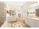 Spacious bathroom featuring double vanity, soaking tub, and tiled floors at 7249 Orchid Island Pl, Bradenton, FL 34202